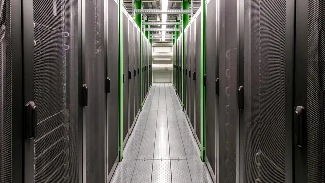 Corridor between server racks in a data center (stock photo, illustrative)